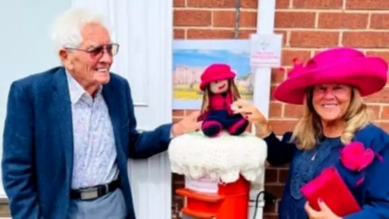 Village knitters create post box cover for 89-year-old community champion