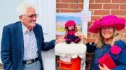 Village knitters create post box cover for 89-year-old community champion
