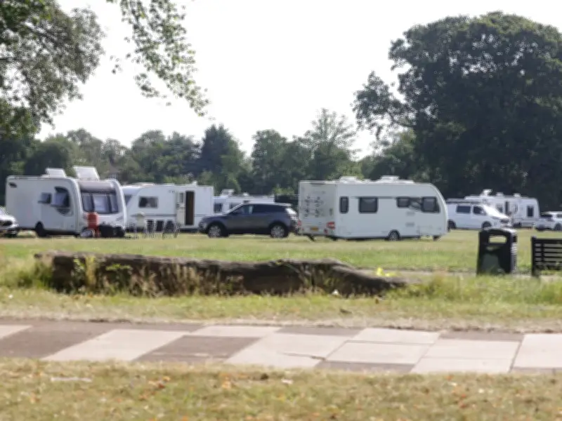 Travellers Set Up Camp at Birmingham Park Near Children's Play Area